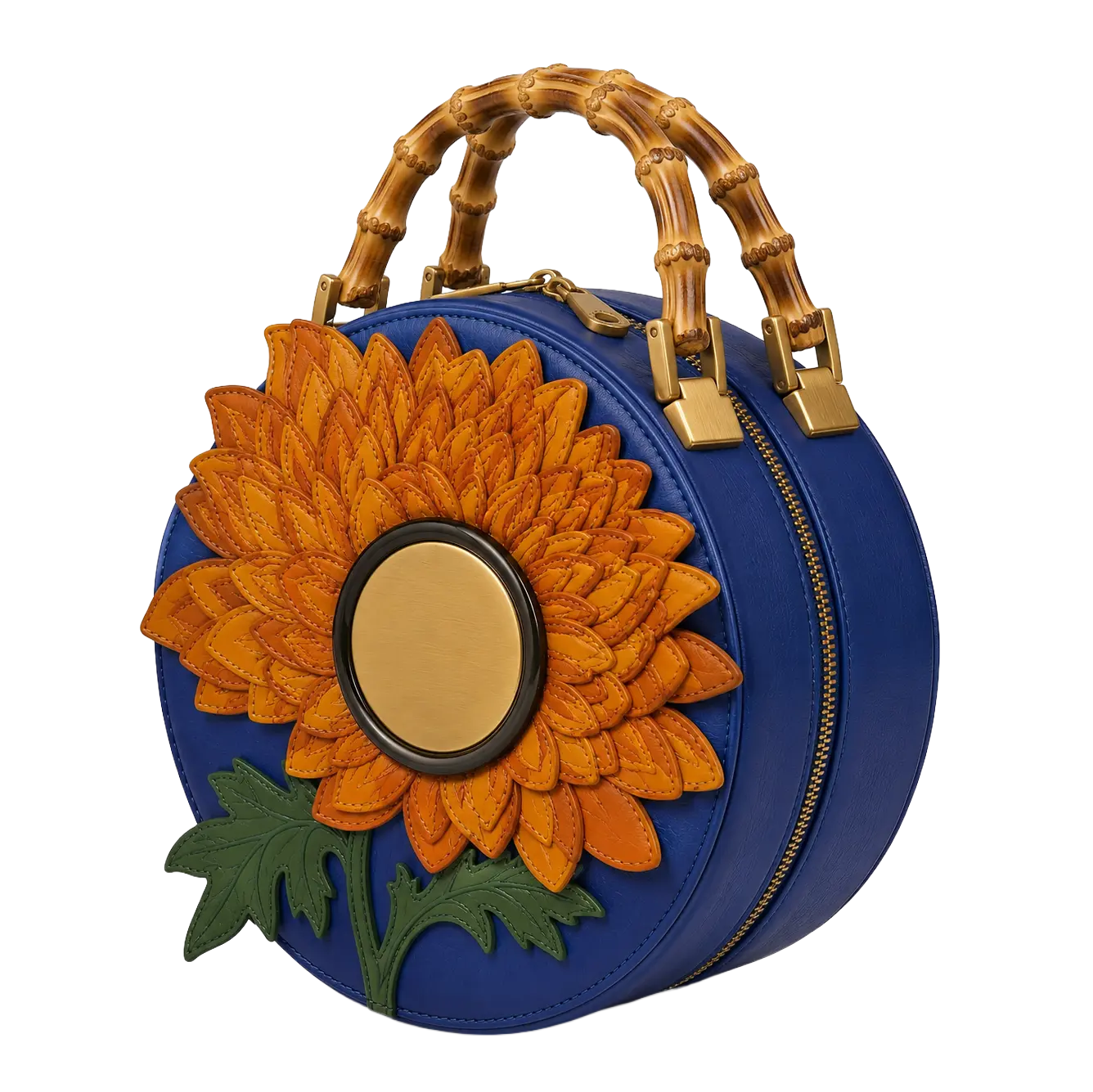 A structured round navy blue leather crossbody bag featuring curved bamboo top handles, gold-tone hardware, and a large 3D layered orange dahlia flower appliqué with a metallic center and green leaves.